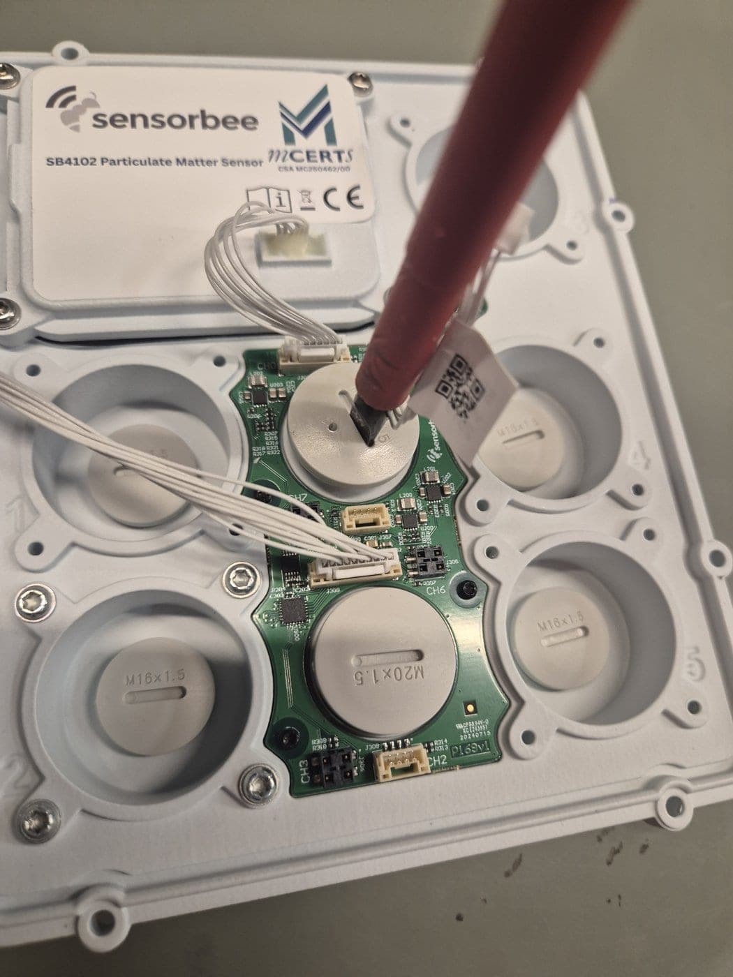 Unscrewing the EnviroSense module with a flat screwdriver
