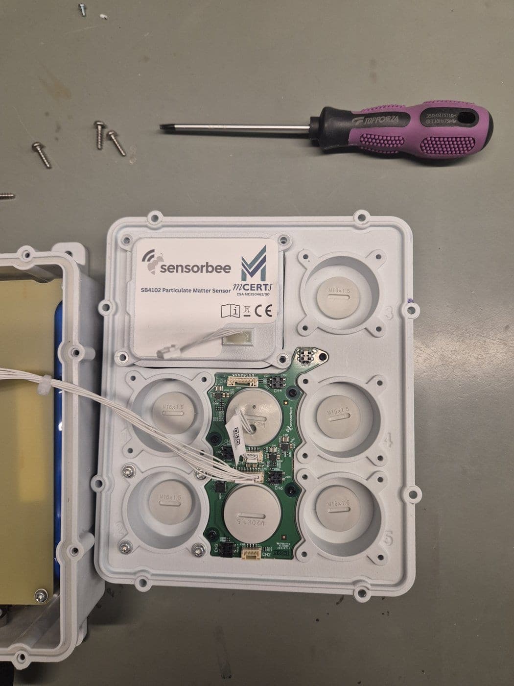 Particle sensor with cable unplugged and the four screws removed