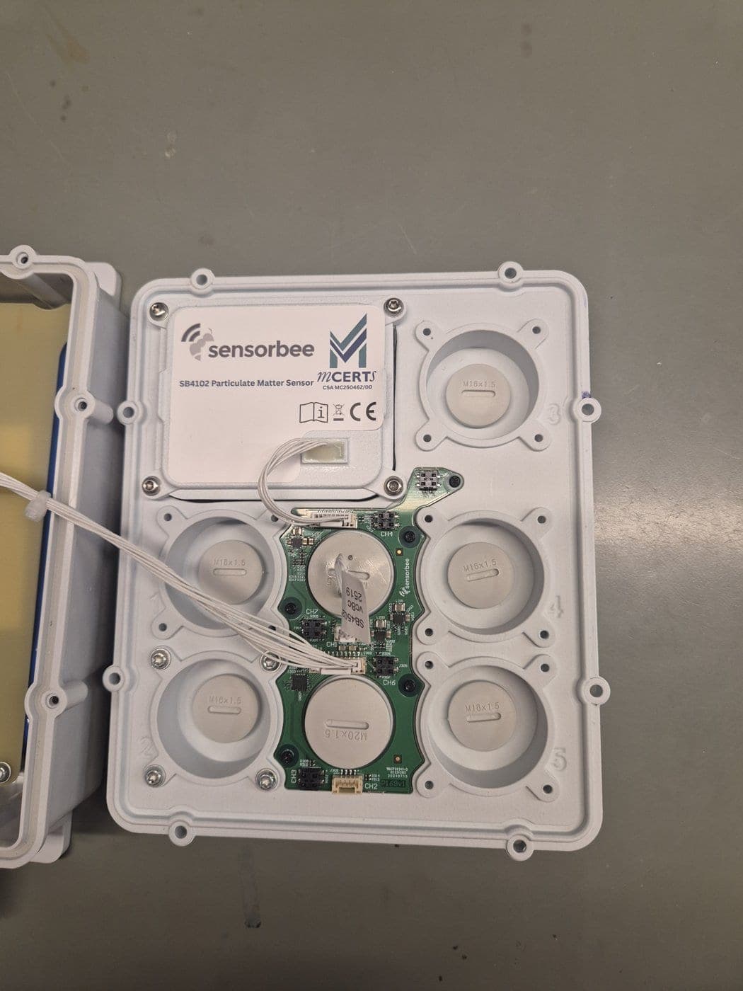 Particle sensor fitted in the lid with its cable plugged into the board